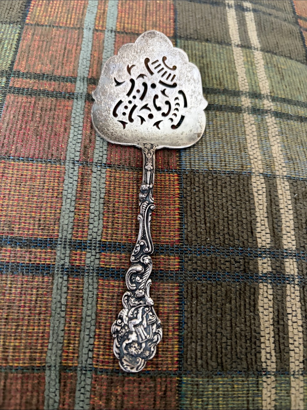 Antique sterling silver pierced bonbon spoon stamped sterling, REPOUSSE handle